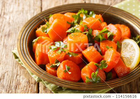Vegetarian carrot salad with cilantro, spices, lemon juice and olive oil close-up in a plate. Horizontal Vegetarian carrot salad with cilantro, spices, lemon juice and olive oil close-up in a plate. Horizontal 114156616