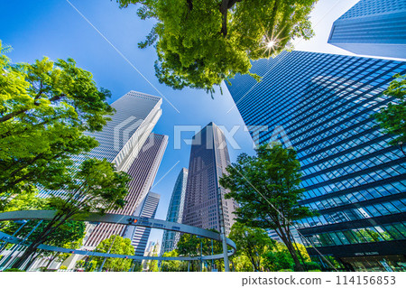 Shinjuku, Tokyo cityscape in Japan. View of Nishi-Shinjuku sign at the intersection behind Shinjuku Police Station and skyscrapers, April 28th 114156853