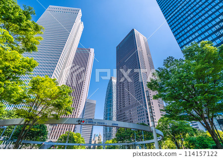 Shinjuku, Tokyo cityscape in Japan. View of Nishi-Shinjuku sign at the intersection behind Shinjuku Police Station and skyscrapers, April 28th 114157122