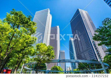 Shinjuku, Tokyo cityscape in Japan. View of Nishi-Shinjuku sign at the intersection behind Shinjuku Police Station and skyscrapers, April 28th Shinjuku, Tokyo cityscape in Japan. View of Nishi-Shinjuku sign at the intersection behind Shinjuku Police Station and skyscrapers, April 28th 114157232