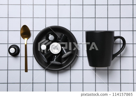 Coffee capsules, spoon and cup on light background, top view 114157865