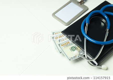 Money with medical equipment, concept of corruption in medicine. Money with medical equipment, concept of corruption in medicine. 114157915