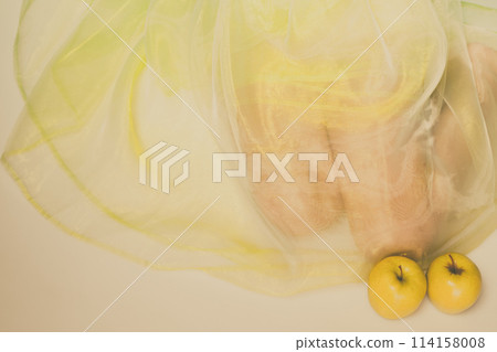 Woman sit in green light dress with apple. Woman sit in green light dress with apple. 114158008