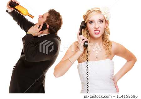 Wedding. Angry bride and groom talking on phone 114158586
