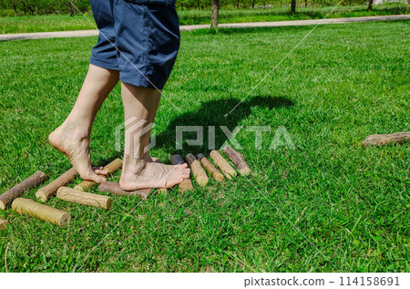 Shot with a close-up on the feet of a Caucasian man walking barefoot Shot with a close-up on the feet of a Caucasian man walking barefoot 114158691