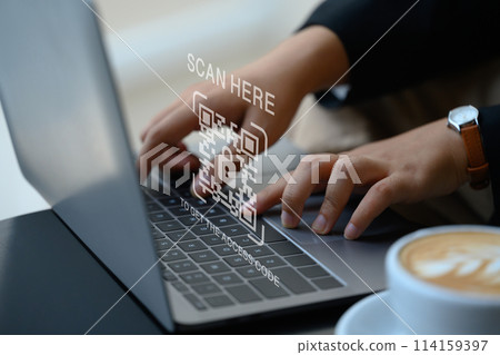 Businesswoman hands typing on laptop with verification QR code login. Cybersecurity concept Businesswoman hands typing on laptop with verification QR code login. Cybersecurity concept 114159397