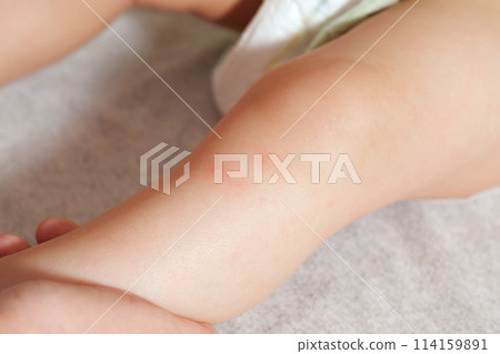 mother massaging little baby legs at home, close up mother massaging little baby legs at home, close up 114159891