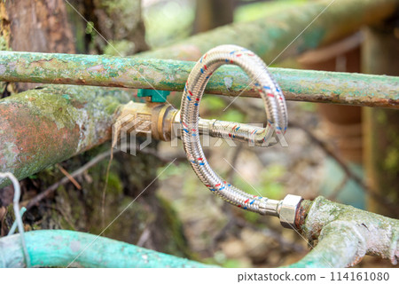 Close-up of metal pipes connected by a hose to prevent leaks. 114161080