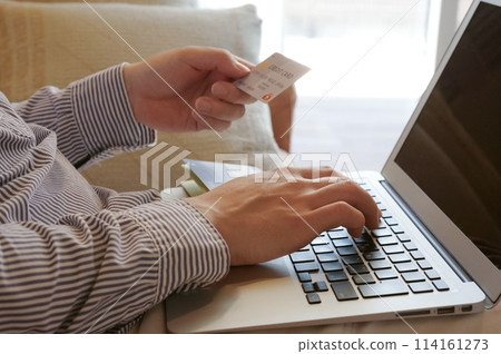 Man entering credit card information 114161273