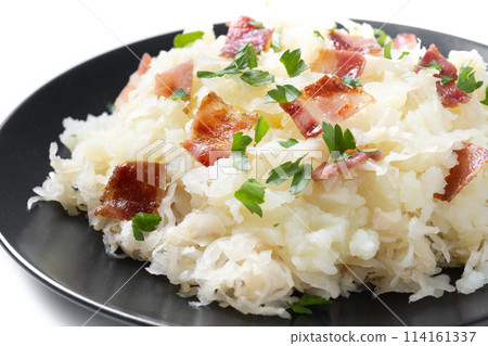 Slovak potato dumplings halusky with steamed sauerkraut and bacon isolated on white background Slovak potato dumplings halusky with steamed sauerkraut and bacon isolated on white background 114161337