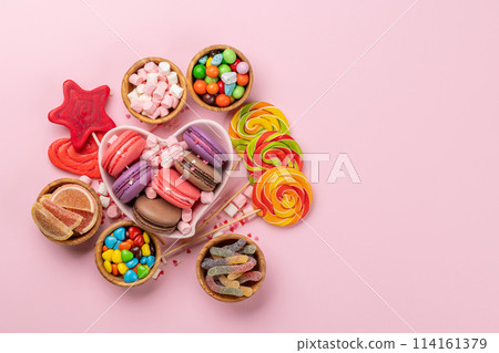 Various colorful candies, lollipops, and macaroons Various colorful candies, lollipops, and macaroons 114161379