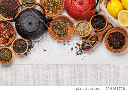 A collection of various teas nestled in wooden bowls A collection of various teas nestled in wooden bowls 114161710