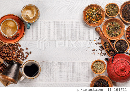A tantalizing display of roasted coffee beans and dry tea leaves, accompanied by an espresso coffee cup and a teapot A tantalizing display of roasted coffee beans and dry tea leaves, accompanied by an espresso coffee cup and a teapot 114161711