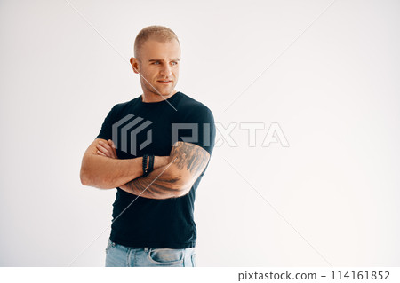 Confident handsome man with arms crossed looking to copy space Confident handsome man with arms crossed looking to copy space 114161852
