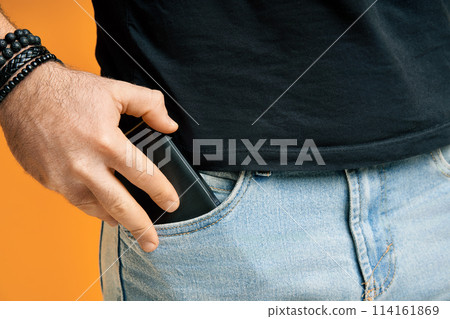 Closeup man take out mobile phone of his pocket Closeup man take out mobile phone of his pocket 114161869