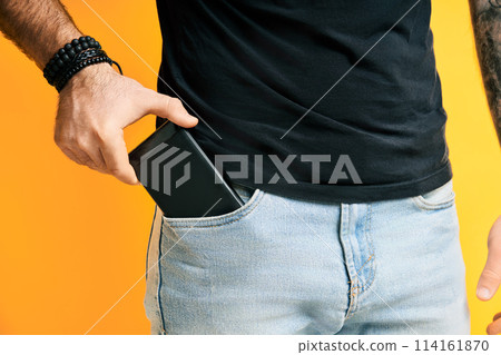 Closeup man take out mobile phone of his pocket 114161870