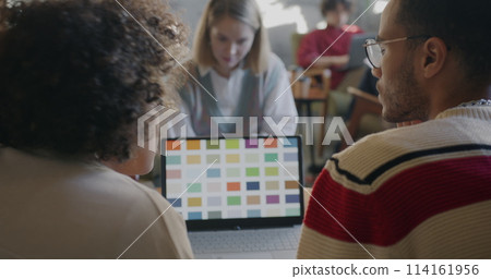 Group of people designers talking and using laptop discussing colors in creative cafe. Start-up and successful entrepreneur concept. Group of people designers talking and using laptop discussing colors in creative cafe. Start-up and successful entrepreneur concept. 114161956