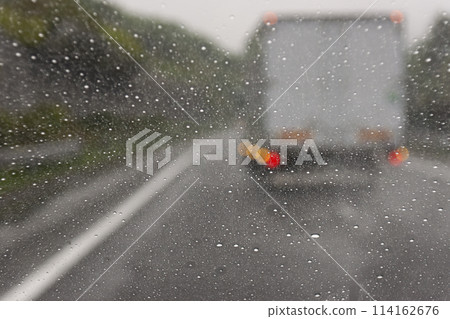 Image of speeding down a rainy highway 114162676