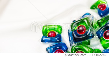 Lots of laundry pods capsule detergent on satin fabric, copy space for text. Lots of laundry pods capsule detergent on satin fabric, copy space for text. 114162782