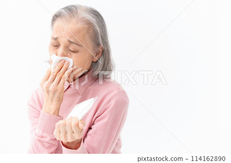 Senior woman blowing her nose Allergy 114162890
