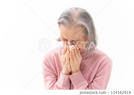 Senior woman blowing her nose Allergy Senior woman blowing her nose Allergy 114162919