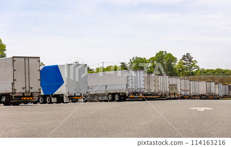 Trucks and trailers parked in a parking lot Trucks and trailers parked in a parking lot 114163216