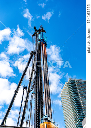 Heavy machinery shining against the blue sky 114163233