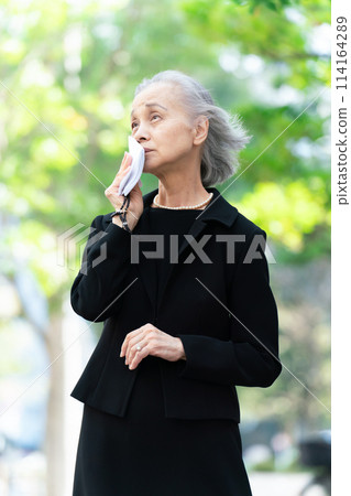 Woman in mourning clothes crying handkerchief Woman in mourning clothes crying handkerchief 114164289
