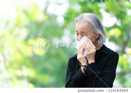 Woman in mourning clothes crying handkerchief 114164304