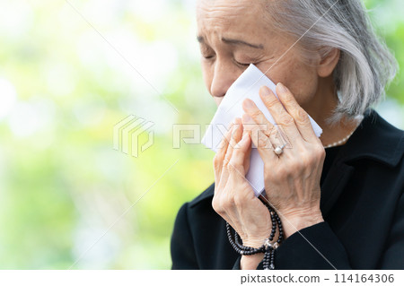 Woman in mourning clothes crying handkerchief 114164306