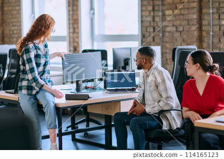 A diverse group of young business individuals congregates in a modern startup coworking center, embodying collaborative innovation and a dynamic atmosphere 114165123