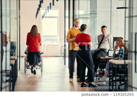 A dynamic group of young entrepreneurs engages in vibrant discussion within a modern glass office space, exploring new business projects and fostering innovation 114165203