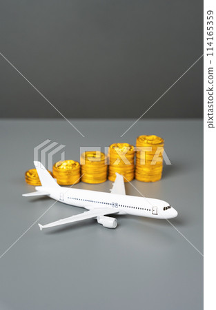 An airplane and a stack of coins symbolizing growth. Increase in income and flight efficiency. Savings on tickets, loyalty program. 114165359