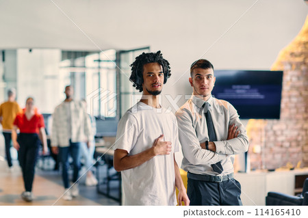 A group of colleagues, including an African American businessman and a young leader in a shirt and tie, pose together in a modern coworking center office, representing a dynamic blend of A group of colleagues, including an African American businessman and a young leader in a shirt and tie, pose together in a modern coworking center office, representing a dynamic blend of 114165410