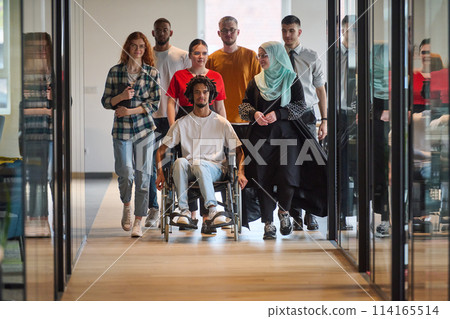 A diverse group of young business people congregates within a modern startup's glass-enclosed office, featuring inclusivity with a person in a wheelchair, an African American young man, and a hijab A diverse group of young business people congregates within a modern startup's glass-enclosed office, featuring inclusivity with a person in a wheelchair, an African American young man, and a hijab 114165514