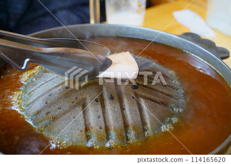 Add oil to the Genghis Khan pot Add oil to the Genghis Khan pot 114165620
