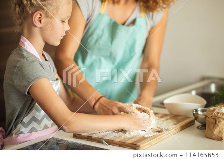 cooking and home concept - close up of female hands kneading dough at home cooking and home concept - close up of female hands kneading dough at home 114165653