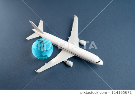 Airplane and blue globe. Construction of new airfields. Development of civil aviation. Travel and business trips. Transport system and infrastructure. Air communication. World flight routes. 114165671