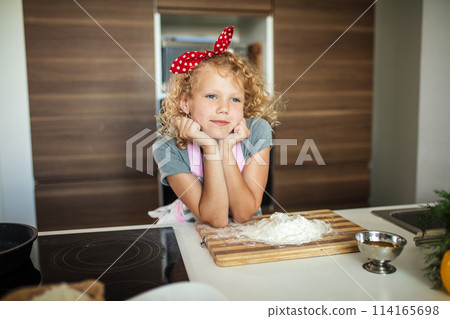 Woman and cute daughter cooking on kitchen, making dough for birthday party. Woman and cute daughter cooking on kitchen, making dough for birthday party. 114165698