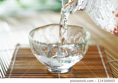 Cold sake (Japanese sake) being poured 114166605