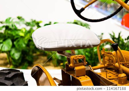 Detail of a small tractor with yellow construction tracks, Caterpillar Ten Detail of a small tractor with yellow construction tracks, Caterpillar Ten 114167188