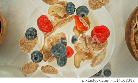 Freeze Motion of Falling Cereals into Bowl with Milk. 114168392