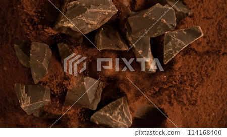 Freeze motion of flying group of raw chocolate pieces. Freeze motion of flying group of raw chocolate pieces. 114168400
