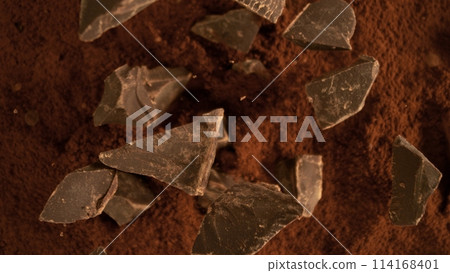Freeze motion of flying group of raw chocolate pieces. 114168401