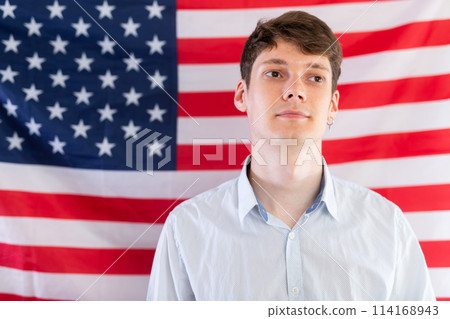 Young guy posing in front of USA flag Young guy posing in front of USA flag 114168943