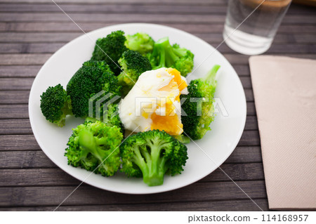 Healthy food. steamed broccoli inflorescences with boiled egg in a bowl 114168957