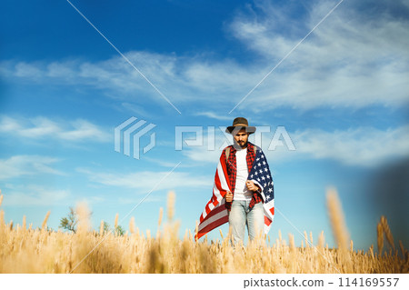 4th of July. American Flag.Patriotic holiday. Traveler with the flag of America. Beautiful sunset light. American style. 4th of July. American Flag.Patriotic holiday. Traveler with the flag of America. Beautiful sunset light. American style. 114169557