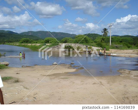 women washing clothes in dam 114169839