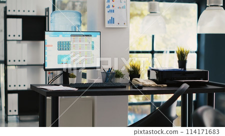 Empty office with stock portfolio on computer monitor containing collection of investment bonds and other financial assets. Real time index indices showing stock demand surge on PC, panning shot 114171683