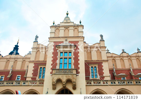 Ancient European architecture. The beautiful facade of the church building on the Market Square in the center of Krakow. Ancient European architecture. The beautiful facade of the church building on the Market Square in the center of Krakow. 114171819